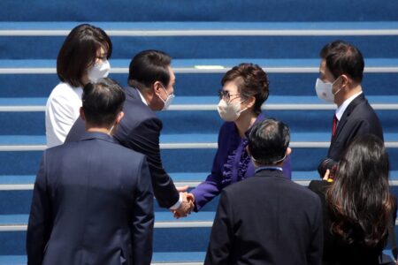 朴槿恵元大統領（右）と握手を交わす尹錫悦大統領